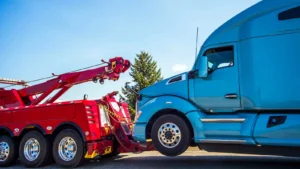 a tow truck with a crane attached to the front of a blue truck